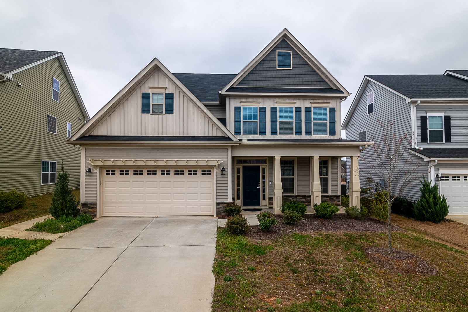Two-story suburban single-family home with two-car garage on a Wasatch Front street